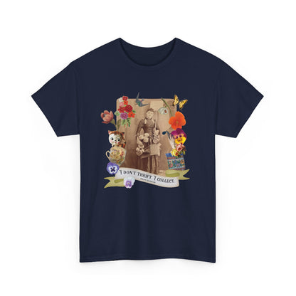A navy blue short-sleeve crewneck t-shirt with a large, colorful graphic print on the front. The graphic features a vintage-style portrait of a couple, surrounded by flowers, butterflies, a cat, and a banner that reads 'I DON'T THRIFT, I COLLECT'.