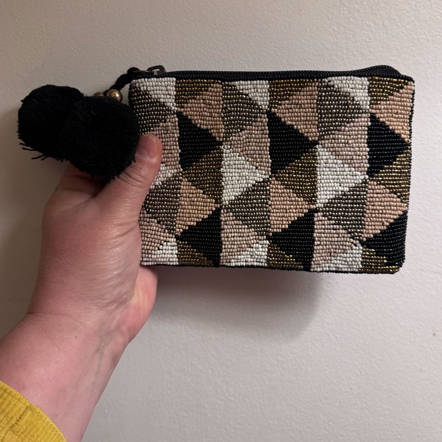 Beaded clutch bag with pom poms
